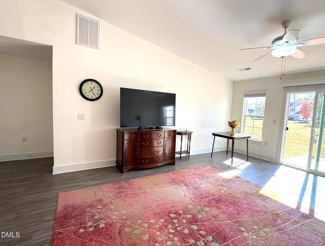 a living room with furniture and kitchen view