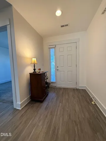 a view of a hallway with wooden floor windows and livingroom