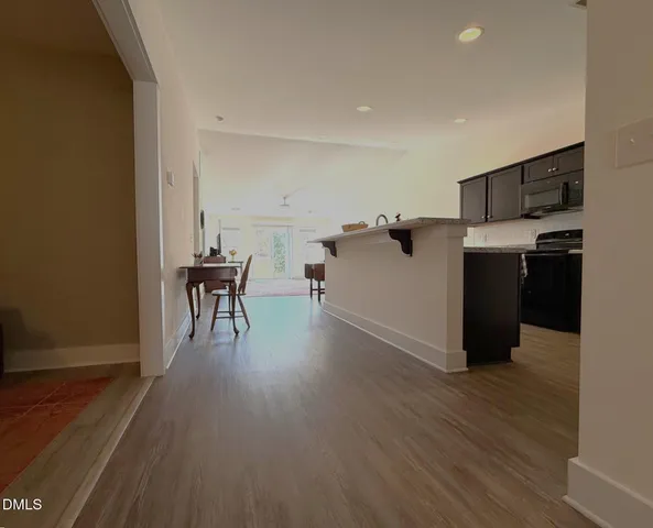 a kitchen with stainless steel appliances granite countertop wooden cabinets a refrigerator and a stove