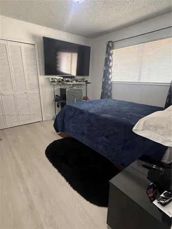 a bedroom with a bed and a closet