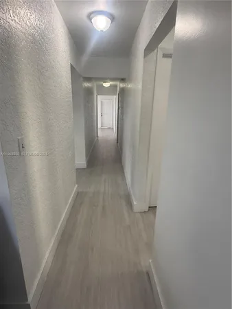a kitchen with wooden cabinets and a stove top oven