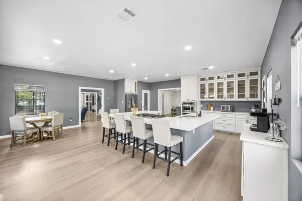 a kitchen with a refrigerator and a stove top oven