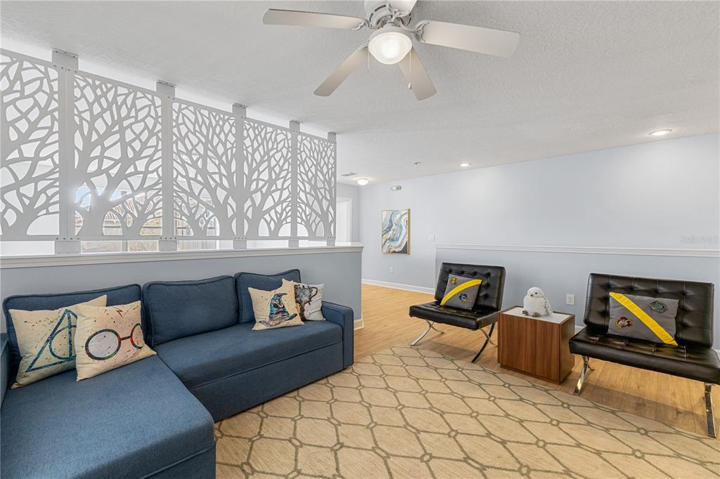 9006 Majesty Palm Road Kissimmee, FL 34747 - Photo 32 of 56 a living room with furniture and a flat screen tv