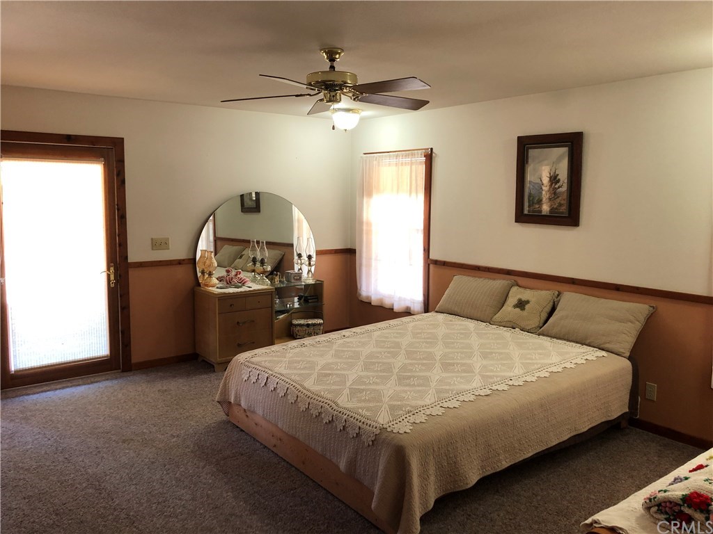 1865 Nacimiento Drive Paso Robles, CA 93446 - Photo 11 of 43 a bedroom with a bed and a chandelier