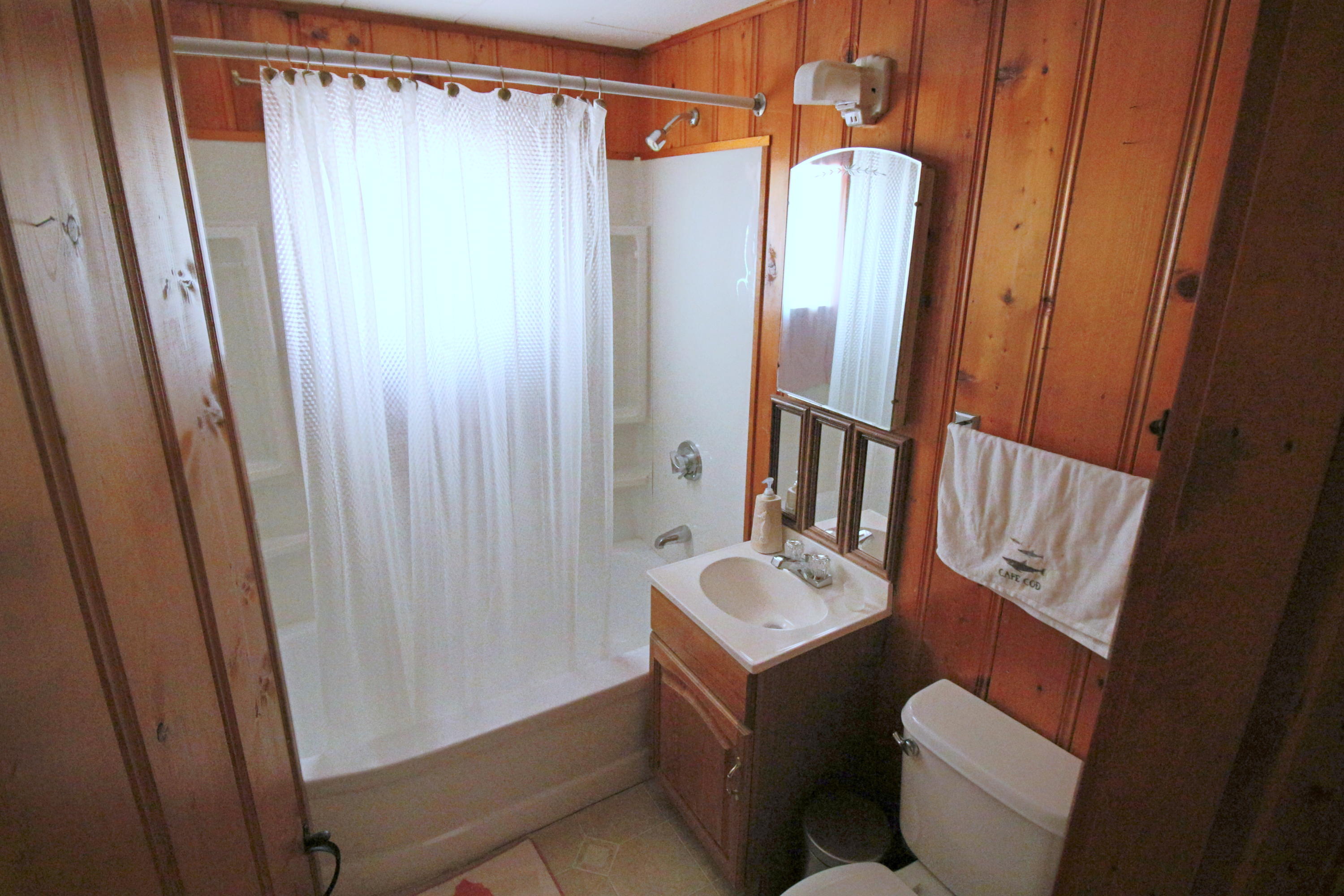 37 Beaten Road Dennis Port, MA 02639 - Photo 11 of 16 a bathroom with a sink a toilet and shower curtain