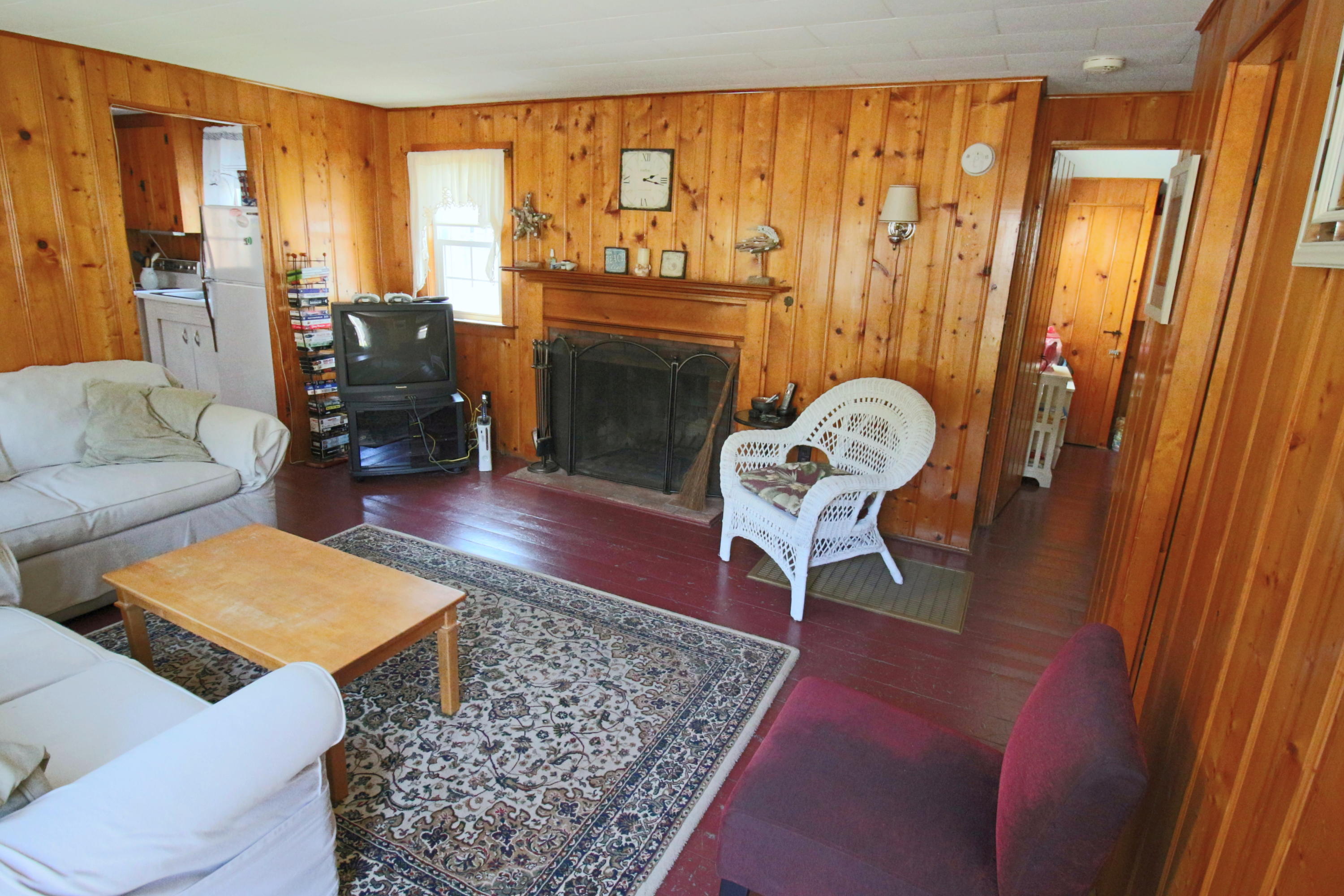 37 Beaten Road Dennis Port, MA 02639 - Photo 4 of 16 a living room with furniture a rug and a fireplace