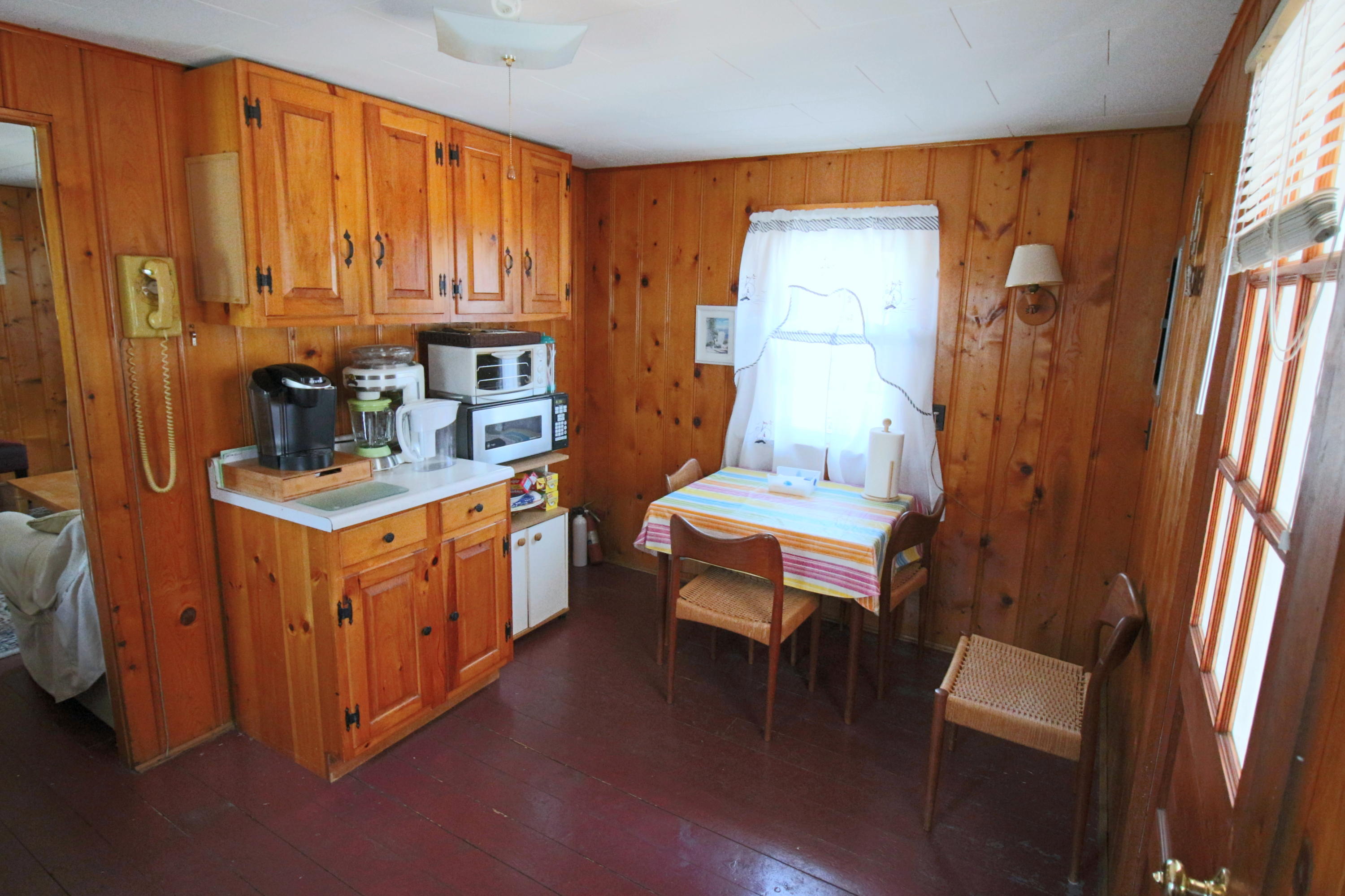 37 Beaten Road Dennis Port, MA 02639 - Photo 7 of 16 a kitchen with stainless steel appliances kitchen island granite countertop a table chairs in it and a window