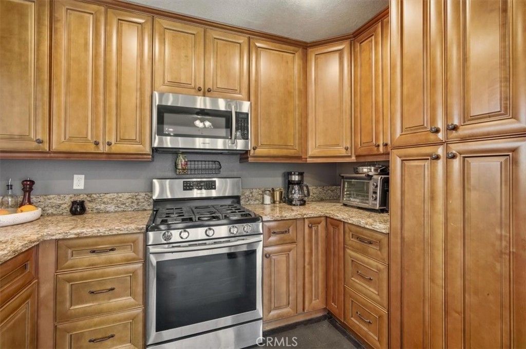 3495 Mono Drive Riverside, CA 92506 - Photo 13 of 34 a kitchen with granite countertop cabinets stainless steel appliances and sink