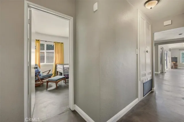 a view of a hallway to a livingroom and a livingroom with furniture