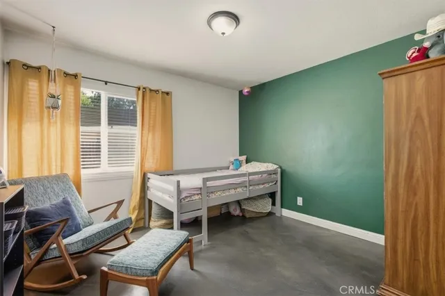 a bedroom with furniture and a window