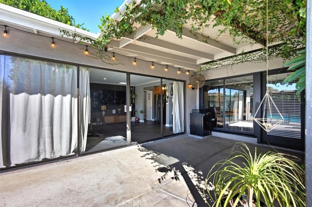 3495 Mono Drive Riverside, CA 92506 - Photo 28 of 36 a view of a patio with table and chairs potted plants and large tree