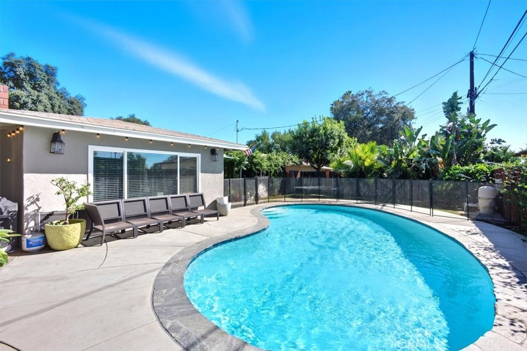 3495 Mono Drive Riverside, CA 92506 - Photo 33 of 36 a view of a swimming pool with potted plants and big trees
