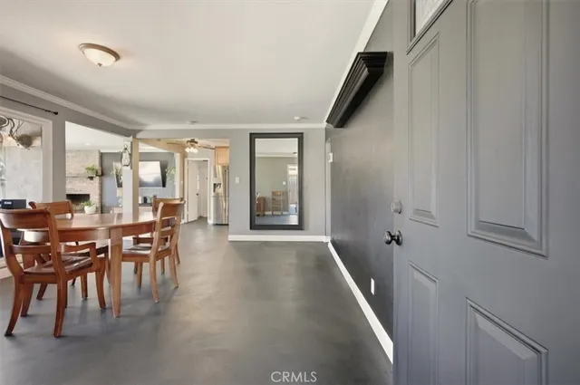 a dining room with furniture and entryway