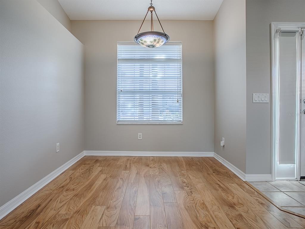 5318 Edgewater Way, Unit 10 Oxford, FL 34484 - Photo 4 of 18 wooden floor in an empty room with a window
