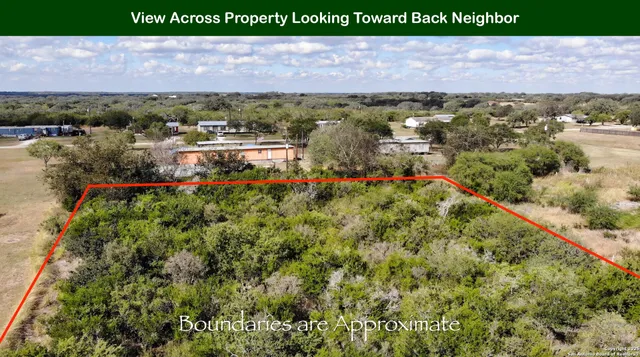 an aerial view of a houses with a yard