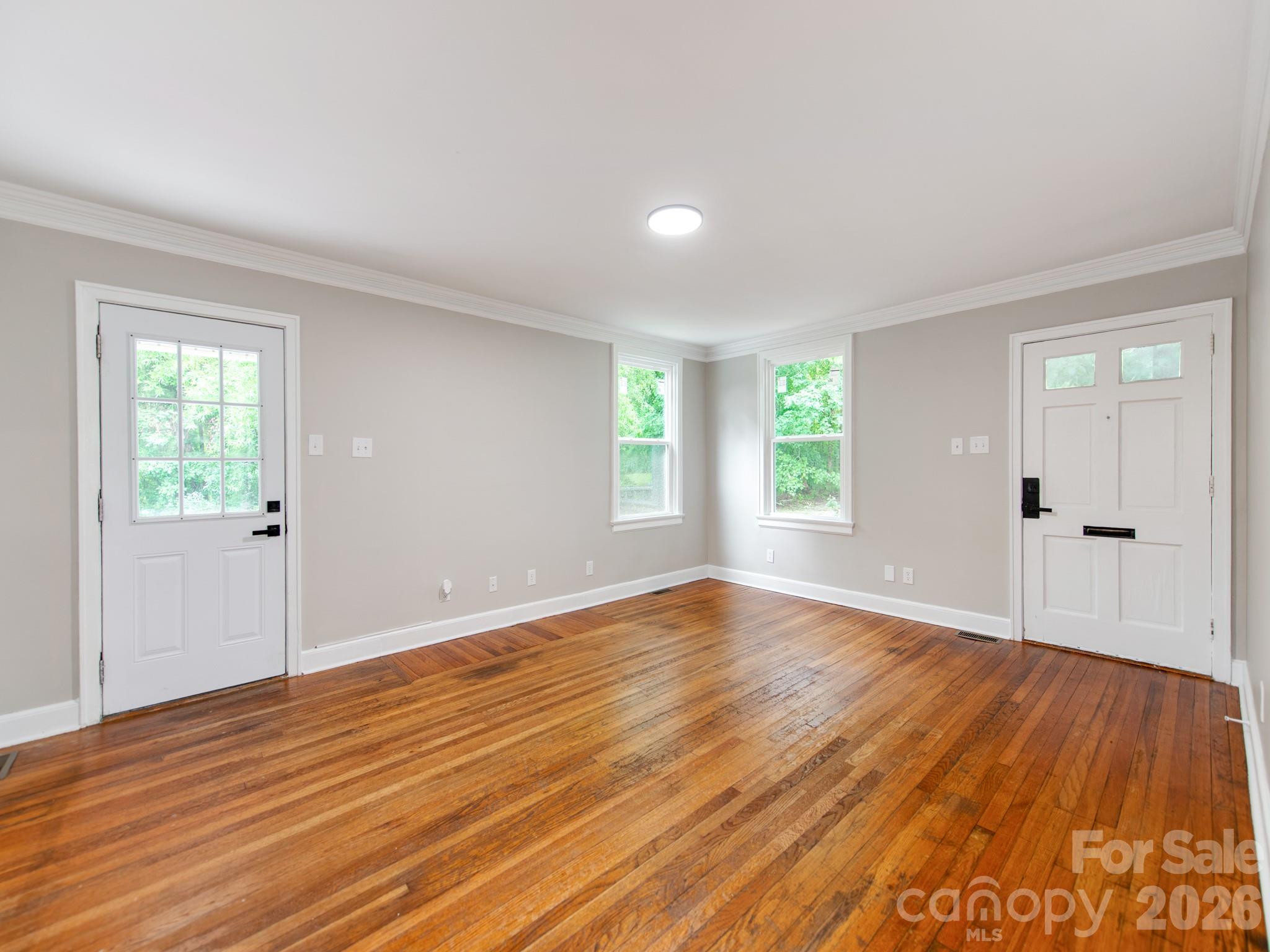 4699 Cherrystone Road Lancaster, SC 29720 - Photo 5 of 28 a view of an empty room with wooden floor and a window