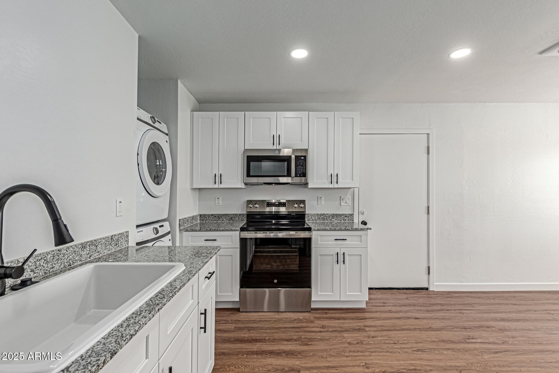 341 South Mountain Road, Unit 4 Apache Junction, AZ 85120 - Photo 9 of 18 a kitchen with a sink cabinets and stainless steel appliances