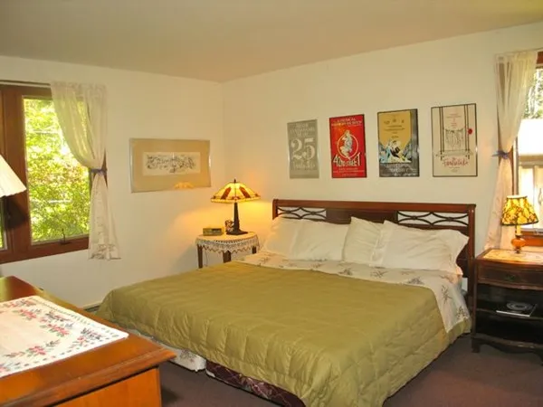 a bed sitting in a bedroom next to a window