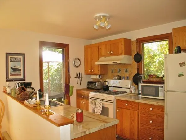 a kitchen with stainless steel appliances granite countertop a sink stove and cabinets