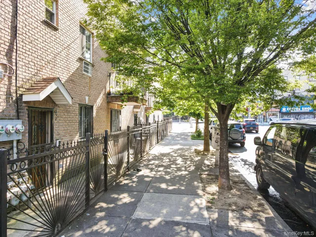 a view of a patio with table and chairs and wooden fence