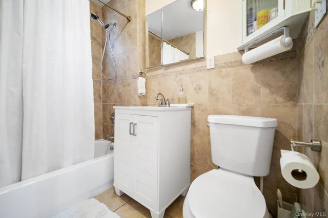 a white toilet sitting next to a bathroom sink