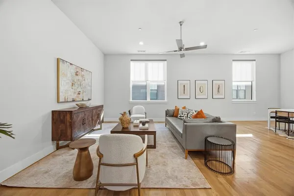 a living room with furniture a chandelier and a table