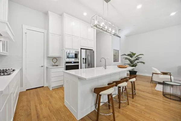 a kitchen with stainless steel appliances granite countertop a refrigerator and a sink
