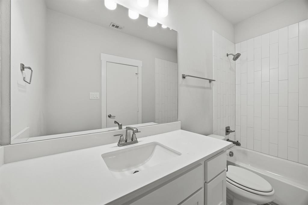 625 North Tyler Street, Unit 402 Dallas, TX 75208 - Photo 19 of 31 a bathroom with a sink a toilet and shower