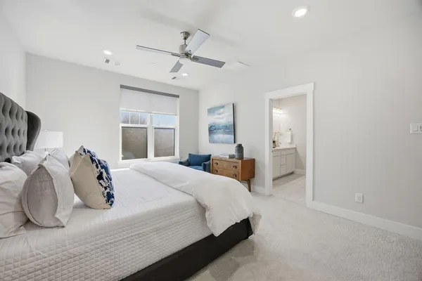 a spacious bedroom with a bed and furniture