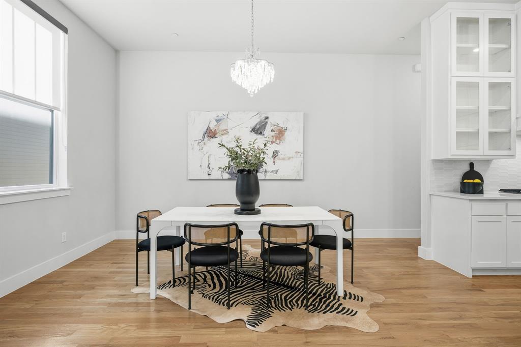 625 North Tyler Street, Unit 402 Dallas, TX 75208 - Photo 8 of 31 a view of a dining room with furniture and wooden floor