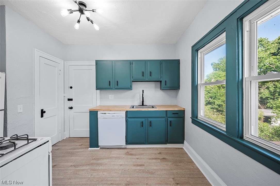 2174 Oakdale Road Cleveland, OH 44118 - Photo 26 of 35 Kitchen featuring plenty of natural light, white appliances, sink, and light hardwood floors