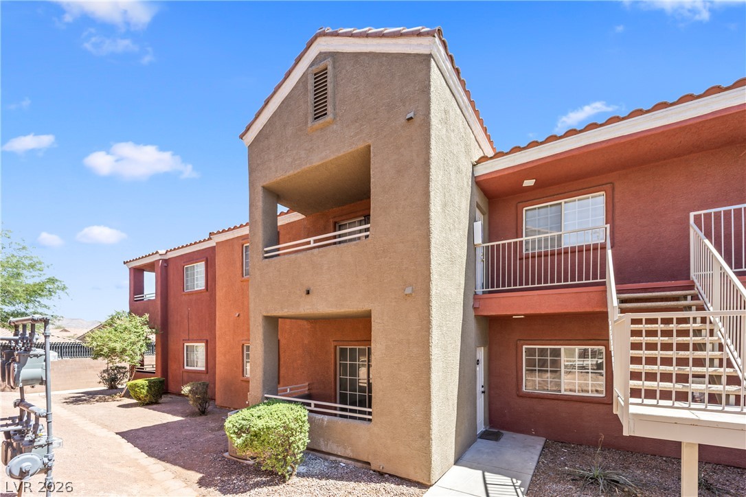 4730 East Craig Road, Unit 1053 Las Vegas, NV 89115 - Photo 22 of 32 A tiered desert landscape building with covered balconies and external stair access.