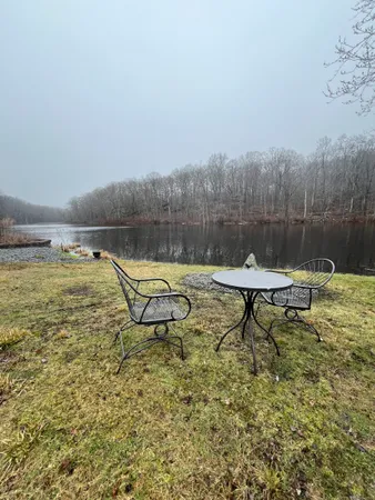 a view of a lake with a bench and some trees