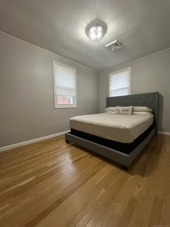 a spacious bedroom with a bed and a window