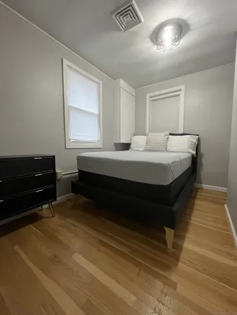 a spacious bedroom with a bed and a cabinets