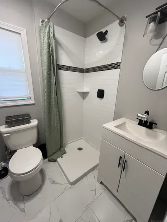 a bathroom with a toilet sink and shower