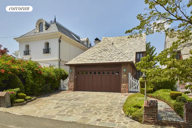 a front view of a house with a garden