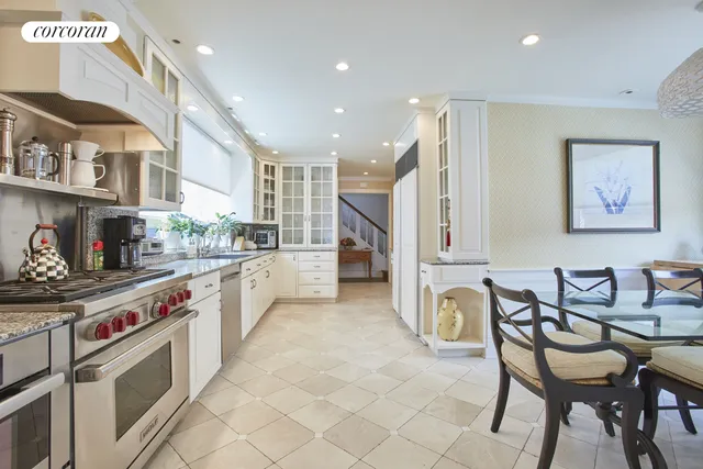 a dining room with furniture a chandelier and wooden floor