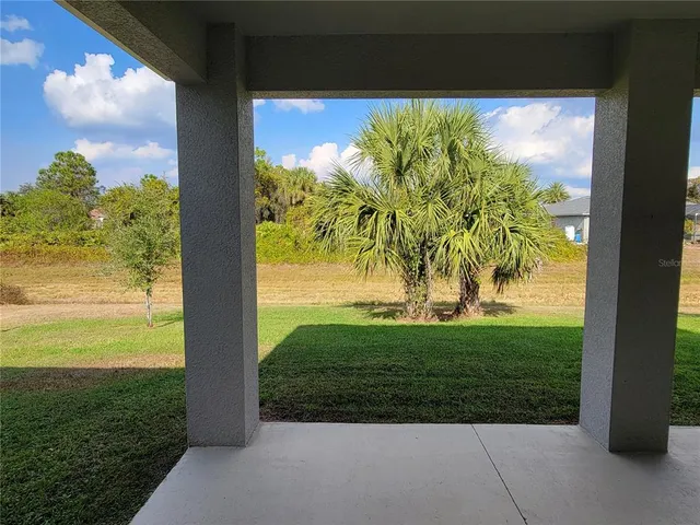 a view of swimming pool with palm trees