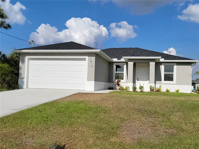 a view of a house with backyard and sitting area