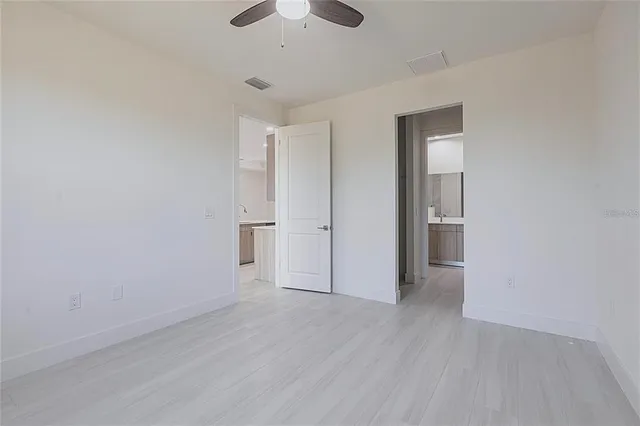 a bathroom with a sink mirror and vanity