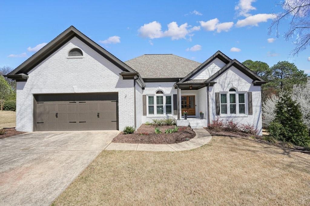 1090 Compton Way Suwanee, GA 30024 - Photo 1 of 106 a front view of a house with a yard and garage