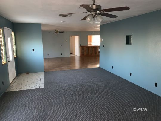 600 South Nevada Street Ridgecrest, CA 93555 - Photo 20 of 30 en empty room with windows and ceiling fan