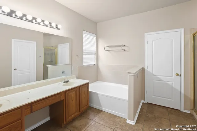 a bathroom with a bathtub and a shower