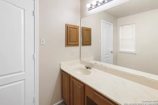 a bathroom with a sink and a mirror