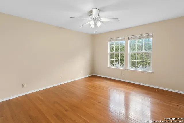 a view of an empty room with wooden floor