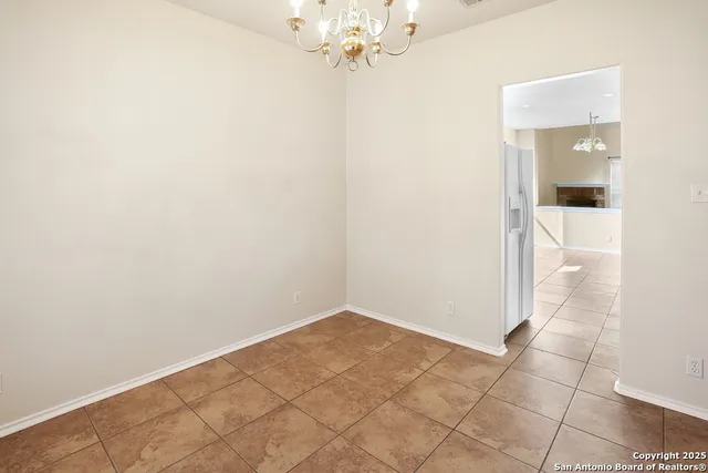 an empty room and chandelier fan