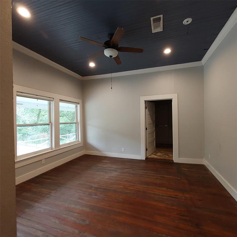 601 Holbrook Street Mount Vernon, TX 75457 - Photo 20 of 35 a view of an empty room with wooden floor and a window