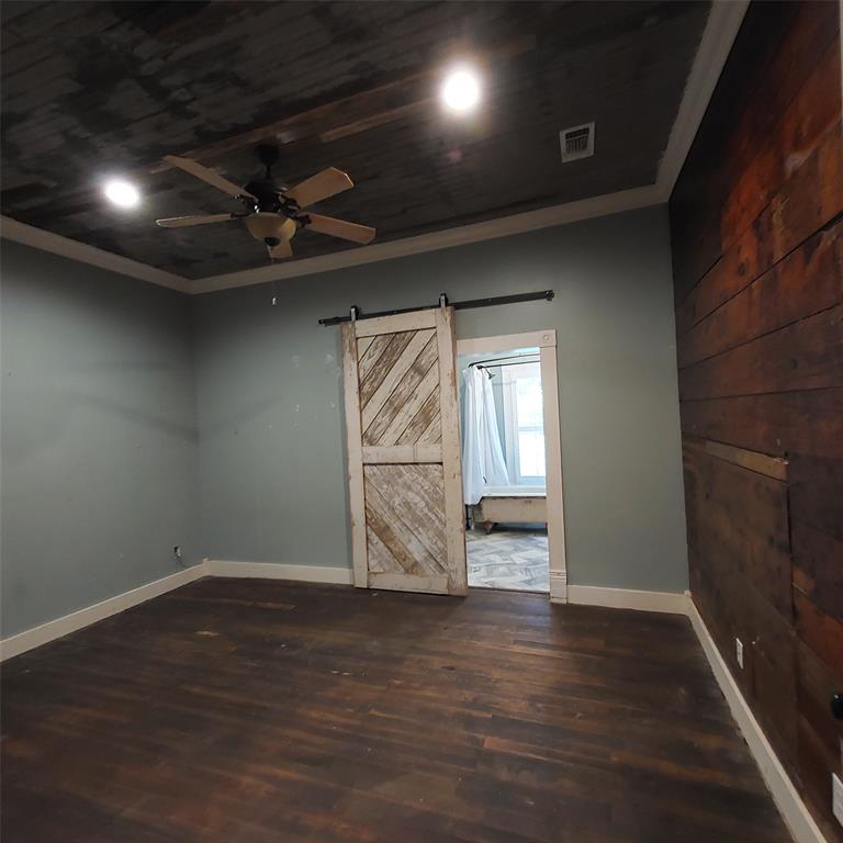 601 Holbrook Street Mount Vernon, TX 75457 - Photo 23 of 35 a view of an empty room with wooden floor and a window