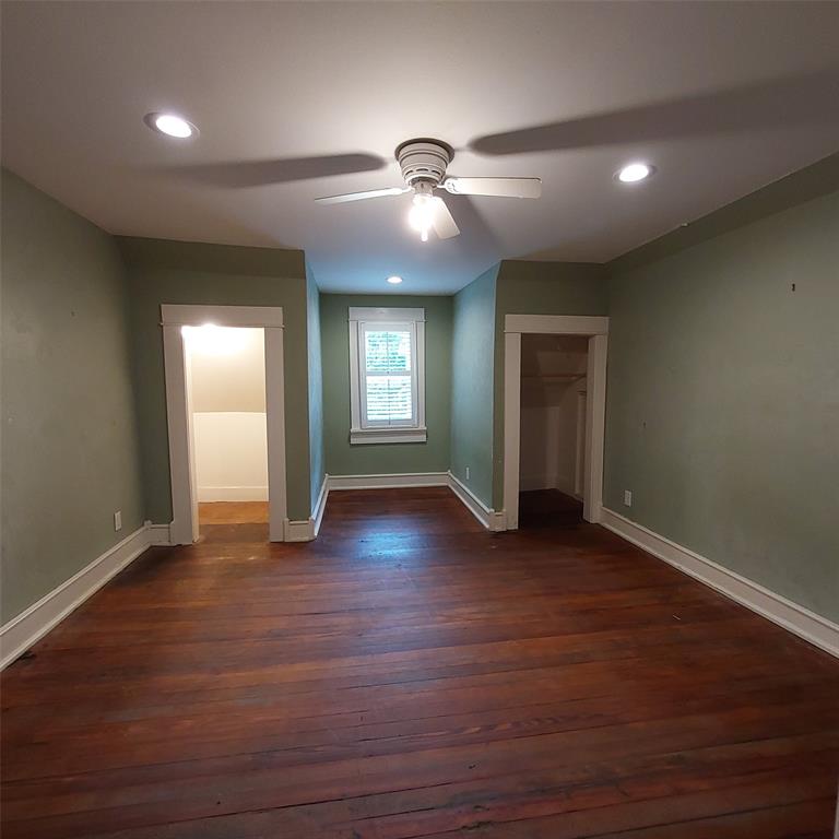 601 Holbrook Street Mount Vernon, TX 75457 - Photo 33 of 35 a view of an empty room with wooden floor and windows